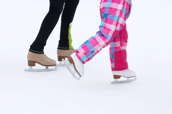 Foot skating little girls and women on an ice rink — Stock Photo, Image