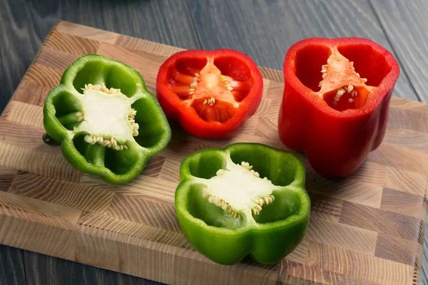 Cut sweet pepper on wooden board — Stock Photo, Image