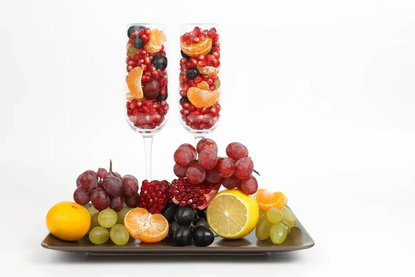 Two glasses filled with fruit on a light background — Stock Photo, Image