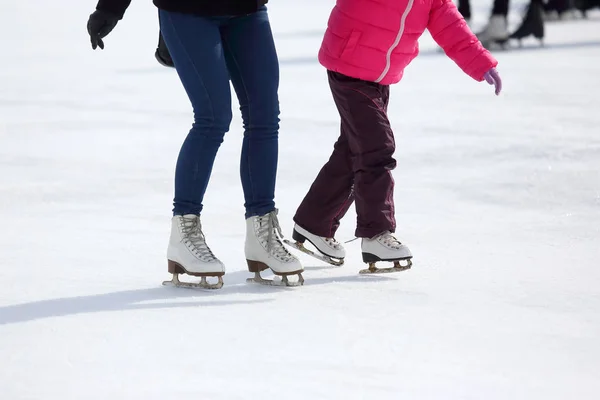 Child and adult skates at the ice rink — Stock Photo, Image