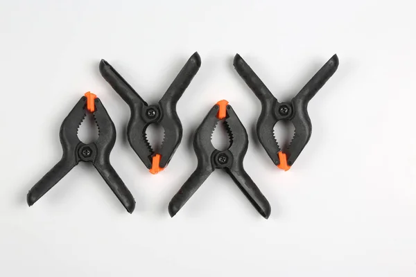 Four black pegs on a white background — Stock Photo, Image