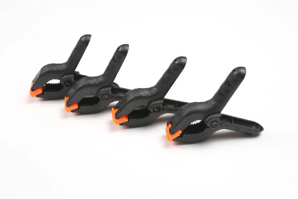 Four black pegs on a white background — Stock Photo, Image