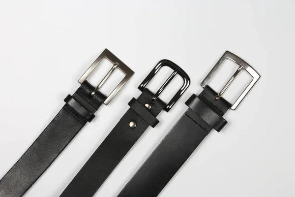 Three black leather belt on a white background — Stock Photo, Image