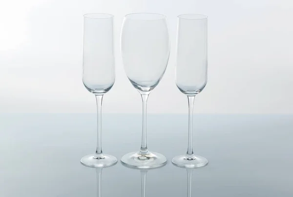 Three empty wine glass on a light backgroun — Stock Photo, Image