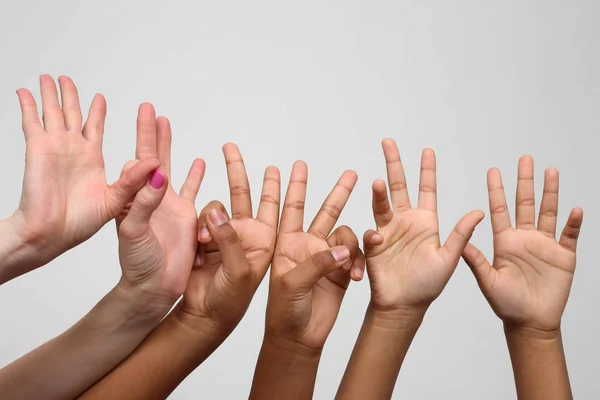 Many raised children's expressive hands in a row — Stock Photo, Image