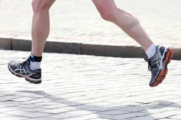 feet running distance athlete on the stone pavement