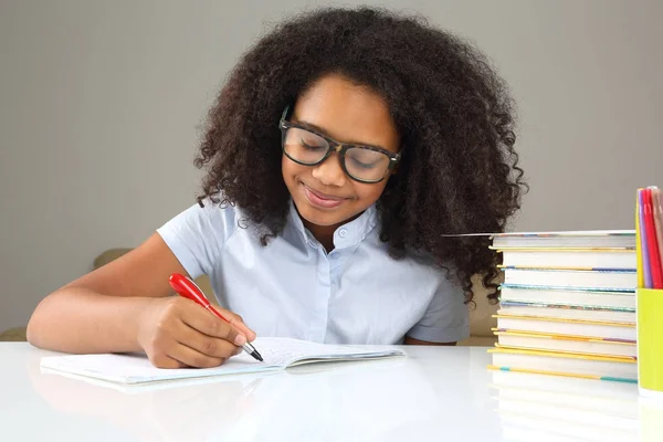 Dark Skinned Schoolgirl Glasses Writes Notebook — Stock Photo, Image