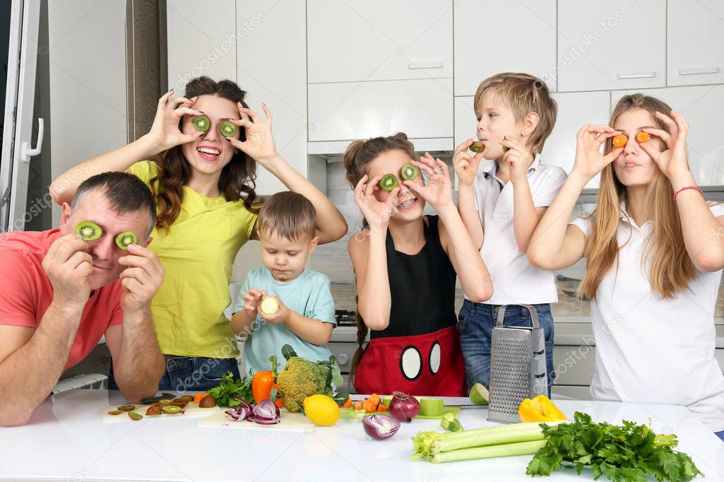 family with children making fun of cooking