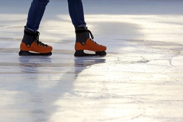The legs of a man skating on the ice rink — Stock Photo, Image