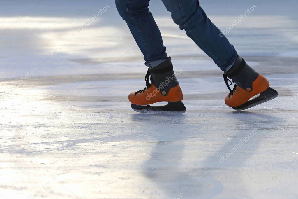 the legs of a man skating on the ice rink