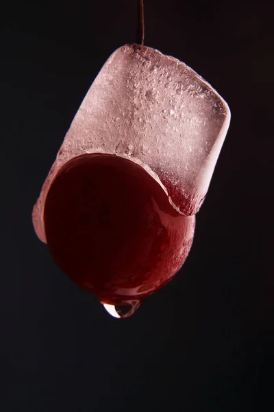 Ice melts on frozen cherries — Stock Photo, Image