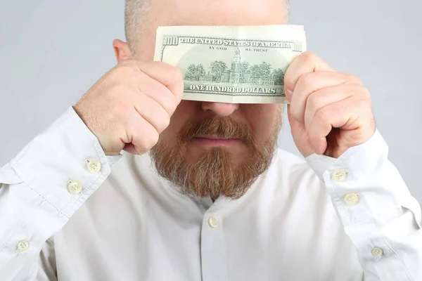 Brodaty mężczyzna zamyka dolara z jego twarzy — Zdjęcie stockowe