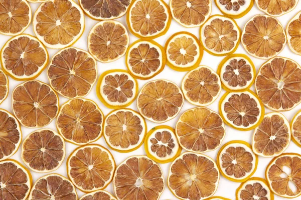 large number of dried lemon slices on a white background. vitami