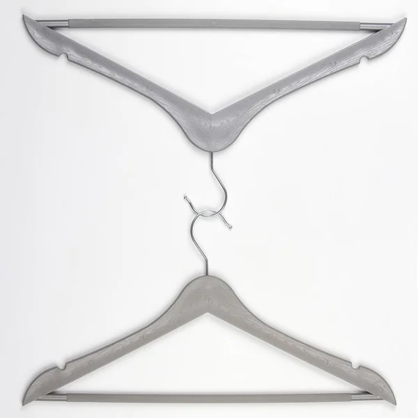 Two gray clothes hangers on a white background. — Stock Photo, Image