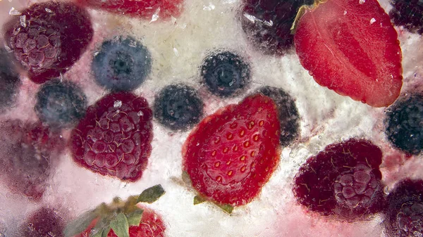 Different juicy berries frozen in ice. useful vitamin healthy fo — Stock Photo, Image