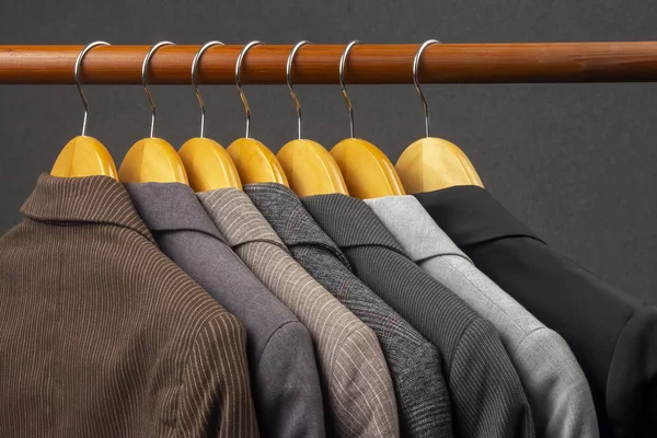 Different women's office classic jackets hang on a hanger for st — Stock Photo, Image