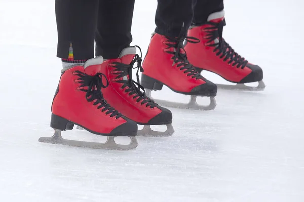 Pés em patins vermelhos em uma pista de gelo. Passatempos e desportos. Férias — Fotografia de Stock