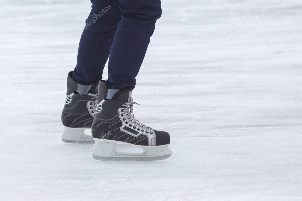 feet on the skates of a person rolling on the ice rink. Hobbies 