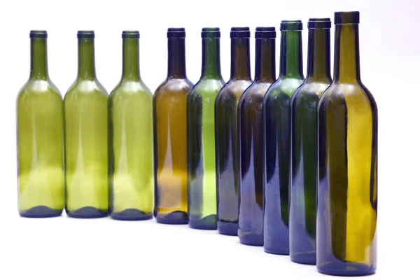 Empty bottles standing in a row on white background — Stock Photo, Image