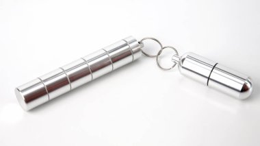 sealed aluminum containers for small items and tablets on a whit