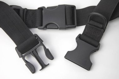 black plastic Fastex clip for backpacks on a white background. i