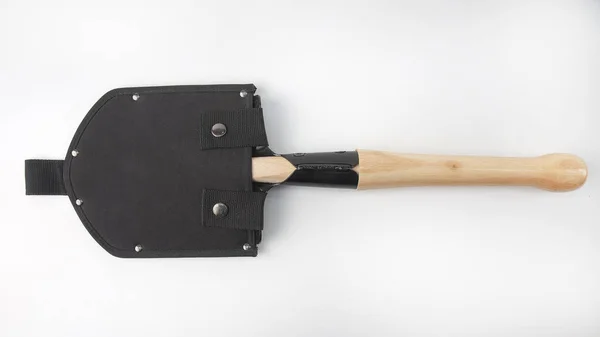 Small shovel for tourism and earthworks with a wooden handle in — Stock Photo, Image