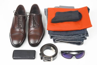 Classic men's shoes, belt, glasses, clothes and mobile phone on 