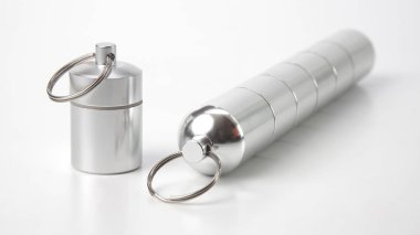 sealed aluminum containers for small items and medical pills on 