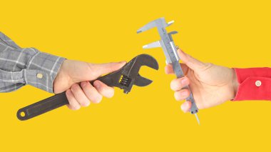 Hands with different working tools. Industry and industrial ente