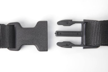 black plastic Fastex clip for backpacks on a white background. i