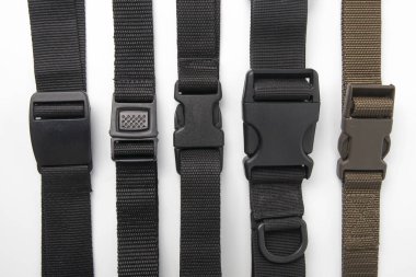 black plastic Fastex clip for backpacks on a white background. i