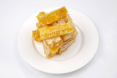 Fresh honey honey on a white plate on a light background. vitami