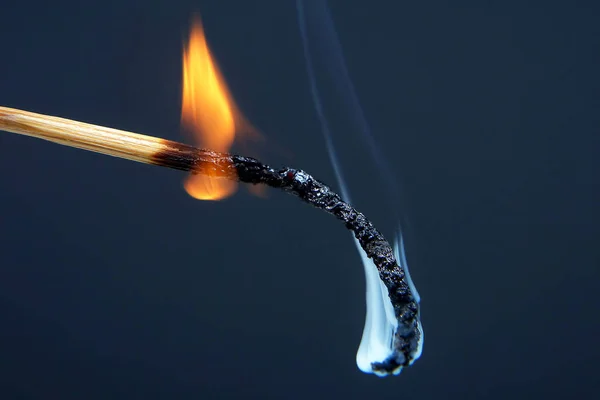 Burning match on a dark background — Stock Photo, Image