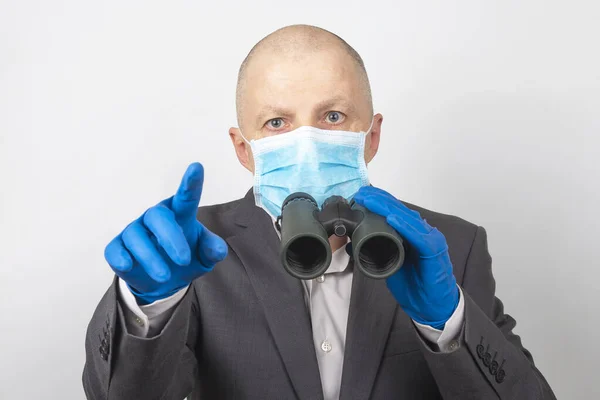 Man Business Suit Medical Mask Protective Gloves Looks Binoculars Goals — Stock Photo, Image