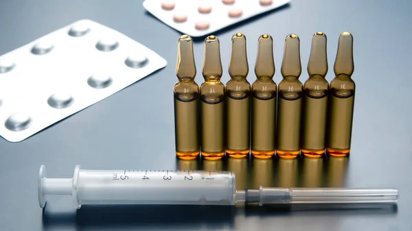 medical ampoules for injection, tablets and syringe. medicines and disease treatment. pharmacology and science