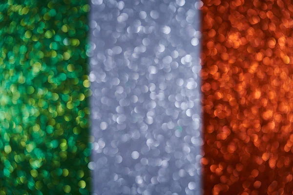 Background image of the flag of Ireland. New Year decoration. Beautiful background from spangles, glitter. Small and large circles