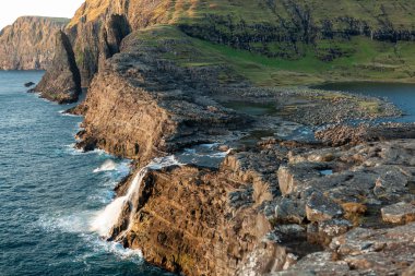 Faroe Adaları 'ndaki gölden okyanusa şelale.