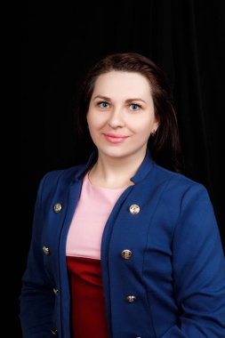 Studio  close up portrait of a girl of Slavic appearance with blue eyes on a black background