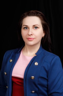 Studio  close up portrait of a girl of Slavic appearance with blue eyes on a black background