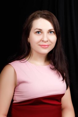 Studio  close up portrait of a girl of Slavic appearance with blue eyes. on a black background