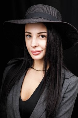 Beautiful woman portrait with a big hat. Vintage look. Fashion makeup. The hat covers half the face
