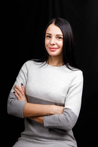 Luxury dark brown straight hair brunette female fashion brown eyes cross hands casual look sensual black background