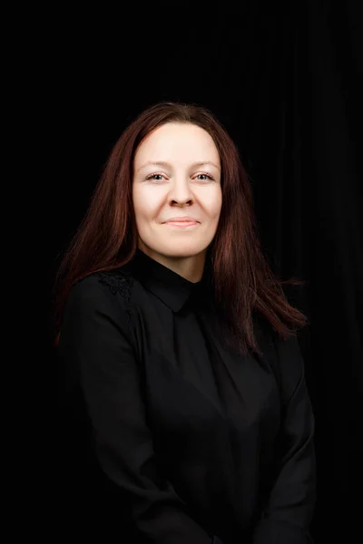 Portrait of successful business woman in  a black shirt with crossed hands on black background — Stock Photo, Image