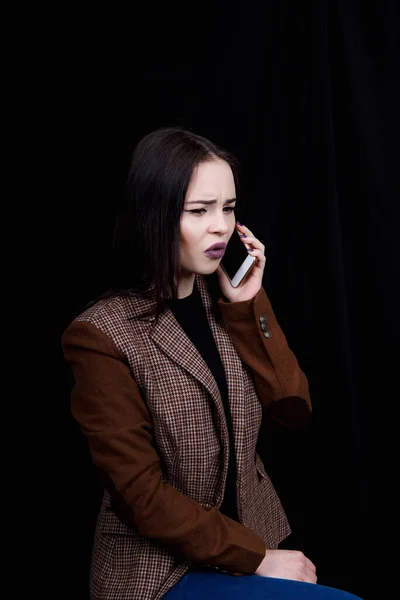 Joyful and successful young woman fashion blogger is emotionally talking on phone. Mulher bonita na jaqueta cinza casual está segurando smartphone — Fotografia de Stock