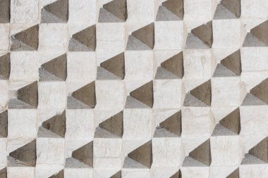 Texture with protruding pyramids of old concrete wall