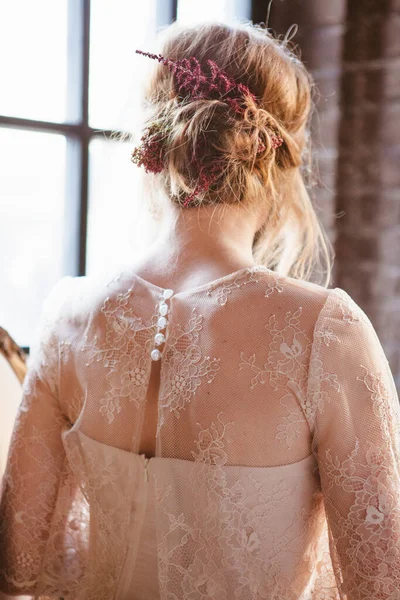 Gentle back and neck of the bride in a wedding dress with a high hairdo