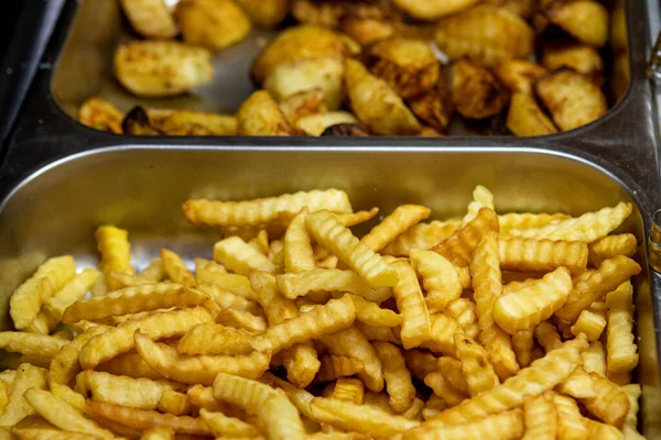 Potato dishes in a fast food restaurant. Fried vegetables