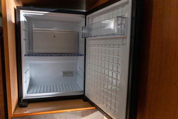 Otel odasındaki mini bar için beyaz boş buzdolabı.