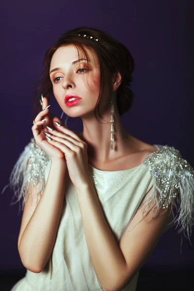 Emotional old-fashioned portrait of a girl in retro style in a light transparent dress with shiny elements on the shoulders. — Stock Photo, Image