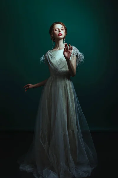 Emotional old-fashioned portrait of a girl in retro style in a light transparent dress with shiny elements on the shoulders. — Stock Photo, Image